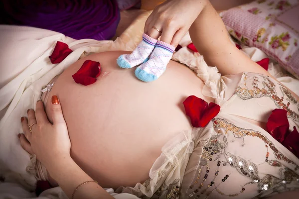 Beautiful pregnant woman in bed at home holding tummy. Pregnancy. Happy pregnant girl in bedroom — Stock Photo, Image