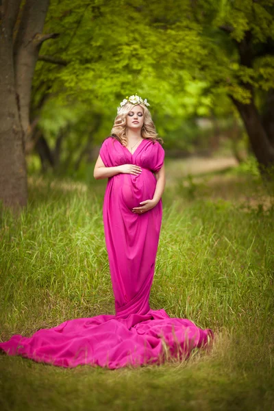 Aantrekkelijke zwangere vrouw over aard, zwangerschap meisje — Stockfoto