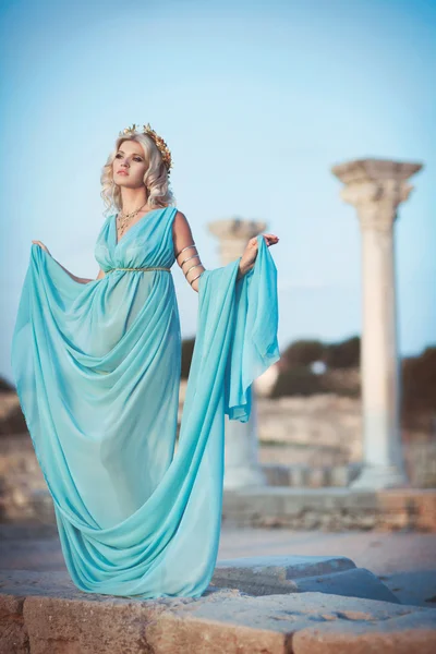 Woman in Greek style on sunset near ancient ruins. — Stock Photo, Image