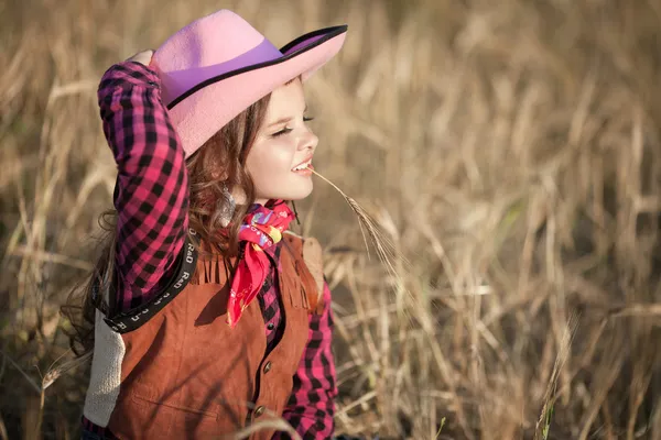 Cowboy girl in golden wheat — Stock Photo, Image