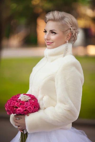 Bride in wedding dress with roses bouquet — Stock Photo, Image