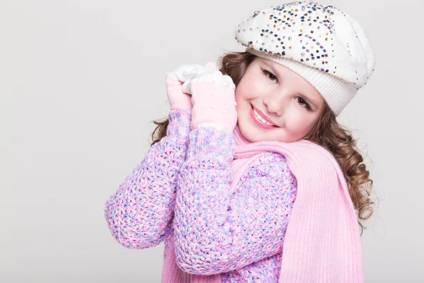 Lovely little girl in winter knitted hat pink scarf gloves and colorful cozy sweater. — Stock Photo, Image