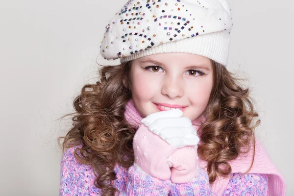 Lovely little girl in winter knitted hat pink scarf gloves and colorful cozy sweater. — Stock Photo, Image