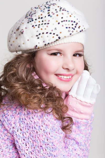 Happy little girl in winter hat and woolen scarf ans colorful sweater isolated. — Stock Photo, Image