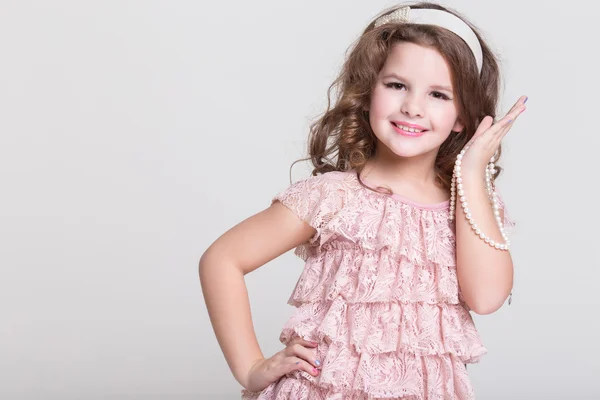 Fashion little girl isolated, lovely girl in beige dress in studio — Stock Photo, Image