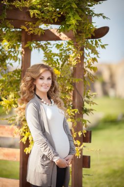 açık havada bahar yeşil bahçesinde mutlu hamile kadın