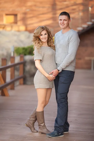 Young pregnant woman with husband walking outdoor and hugs tummy — Stock Photo, Image