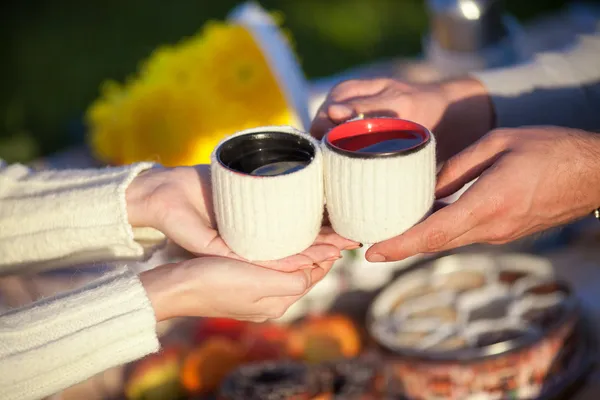 Çift üzerinde piknik park, erkek ve kadın ile havada üzerinde uzanan sıcak kahve espresso fincan çay içme
