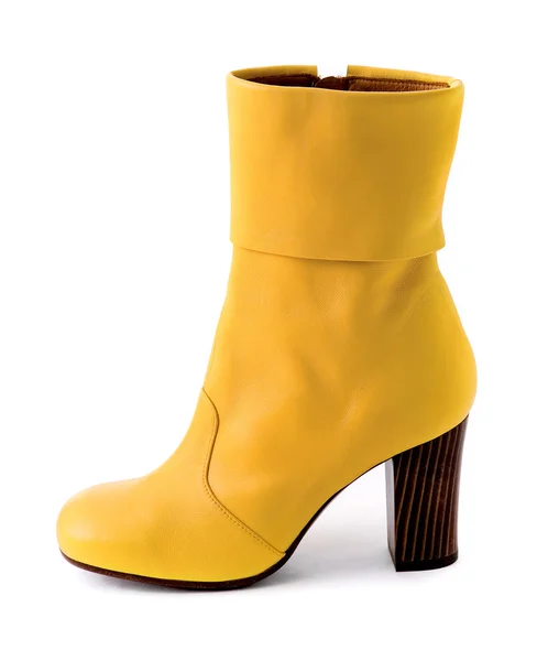 Elegant yellow leather boot with wooden heel — Stock Photo, Image