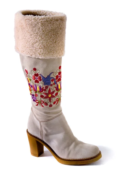 Botas de gamuza blanca con puño de piel de ave y flores bordadas Imágenes de stock libres de derechos