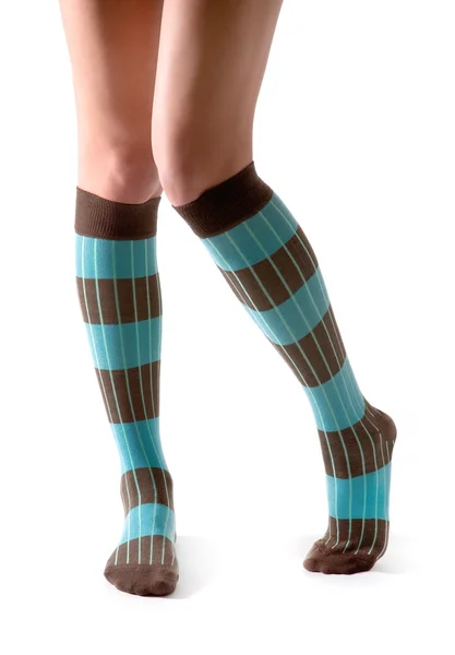 Jonge vrouw benen poseren met turquoise gestreepte sokken — Stockfoto