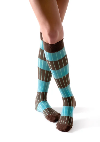 Young woman crossed legs posing with turquoise striped socks — Stock Photo, Image