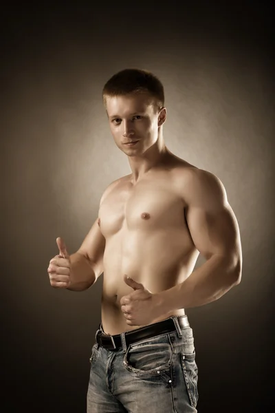 Healthy muscular young man posing in studio — Stock Photo, Image