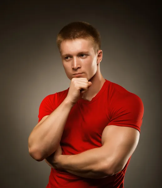 Healthy muscular young man posing in studio — Stock Photo, Image