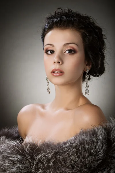Portrait of a young girl in a fur coat — Stock Photo, Image