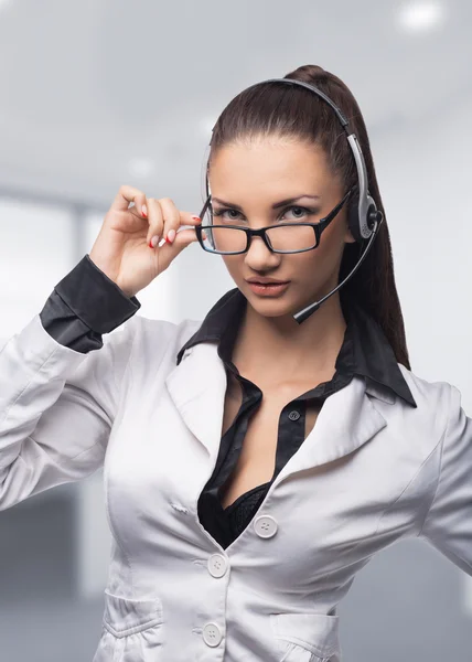 Businesswoman in headset in office — Stock Photo, Image