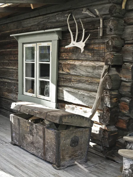 Old cabin window with the ark and antlers