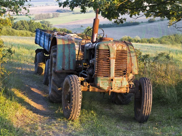 Small tractor with a wagon in the field of nature and countryside in the background — Stock Photo, Image