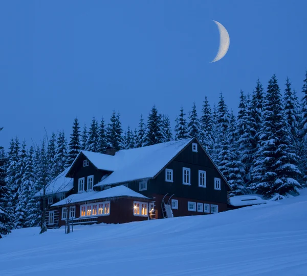 Mountain cottage in winter moonlit night — Stock Photo, Image