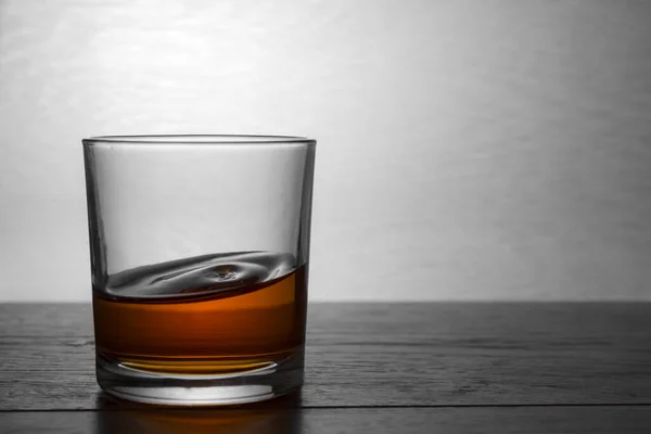 whiskey glass, cognac drink and whisky on wooden table, closeup
