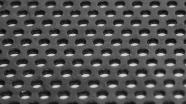Gray perforated metal plate. Aluminum texture. Holes in metal. Lots of holes. Radiator grille. Element of decor.