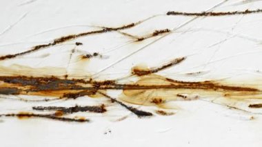 Rusty scratches on the white painted wall