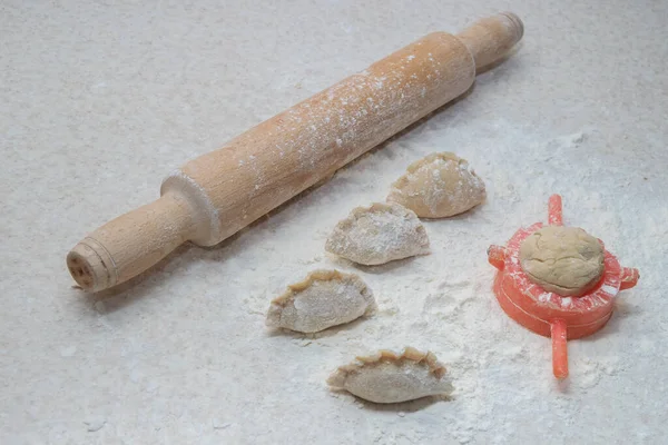 Appetizing dumplings, vareniki, ravioli. Boiled dough with filling. Traditional dish of Ukraine, Italy, Asia. Dumplings with meat, fish, vegetables. A hearty breakfast, lunch, dinner.