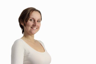 The girl is happy that she is pregnant. Happy woman in white clothes. The pregnant woman folded her arms in the shape of a heart.