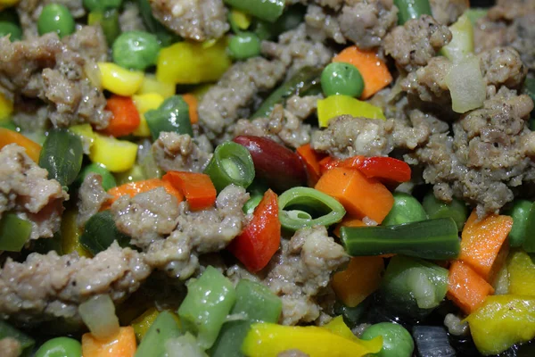 Meat with green peas, corn, green beans and sweet peppers.