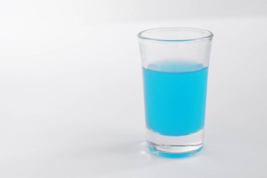 Glass of blue alcohol. Shot of blue in a glass.
