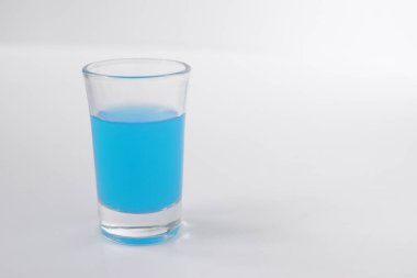 Glass of blue alcohol. Shot of blue in a glass.