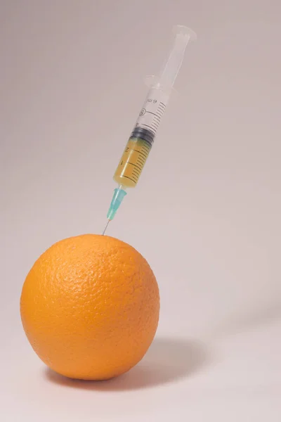 Injecting Yellow Liquid Orange Fruit Syringe Yellow Liquid White Background — Stok fotoğraf