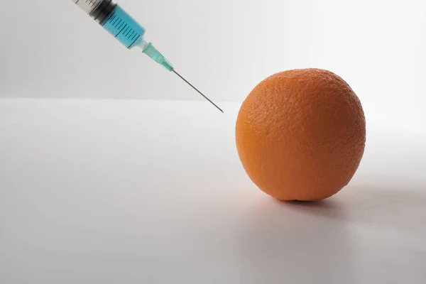 Injecting Blue Liquid Orange Fruit Syringe Blue Liquid White Background — Fotografia de Stock