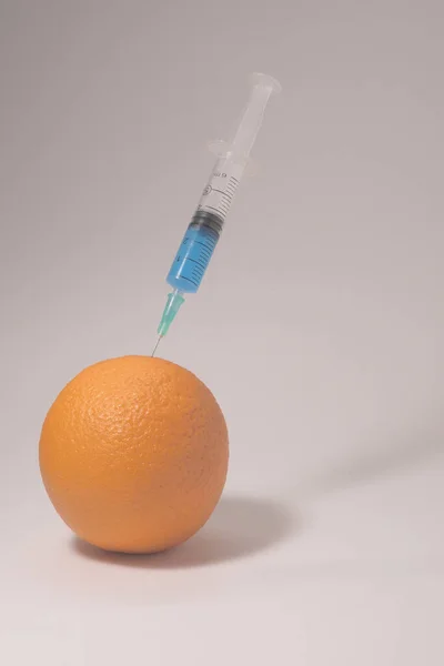 Injecting Blue Liquid Orange Fruit Syringe Blue Liquid White Background — ストック写真