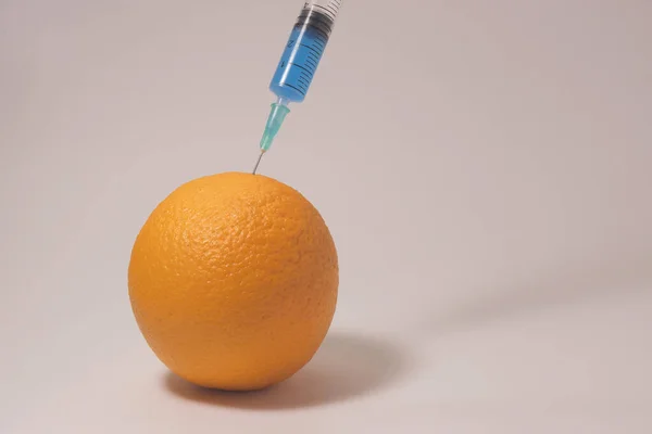 Injecting Blue Liquid Orange Fruit Syringe Blue Liquid White Background — Photo