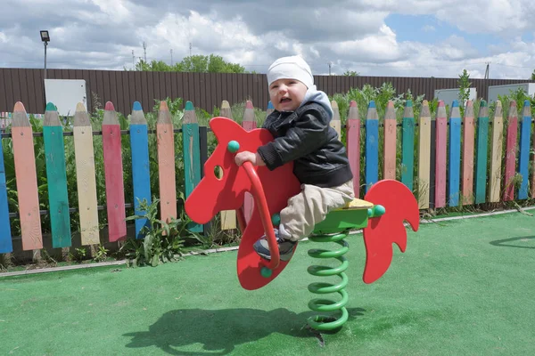 Toddler is playing in the playground. Kid in the playground. 