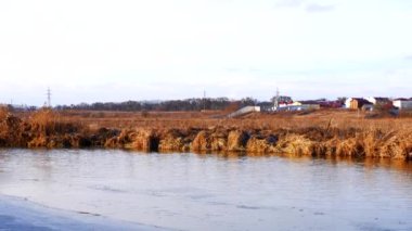 First frosts. The river starts to ice. Winter river. Rural landscape. Cold mountain river.