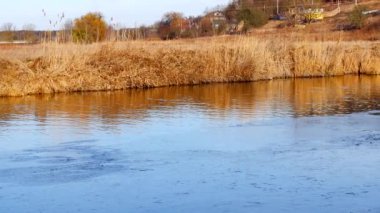 First frosts. The river starts to ice. Winter river. Rural landscape. Cold mountain river