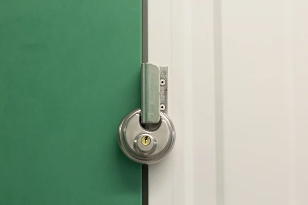 Round heavy duty pad lock on self storage unit — Stock Photo, Image