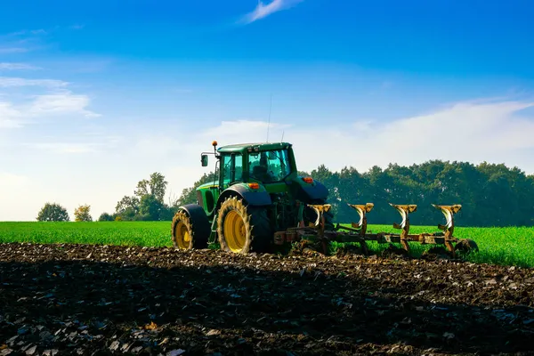 Tractor farm. Agriculture farm machinery on landscape land field. Farmer machine equipment for crop. Tractor farm fields concept