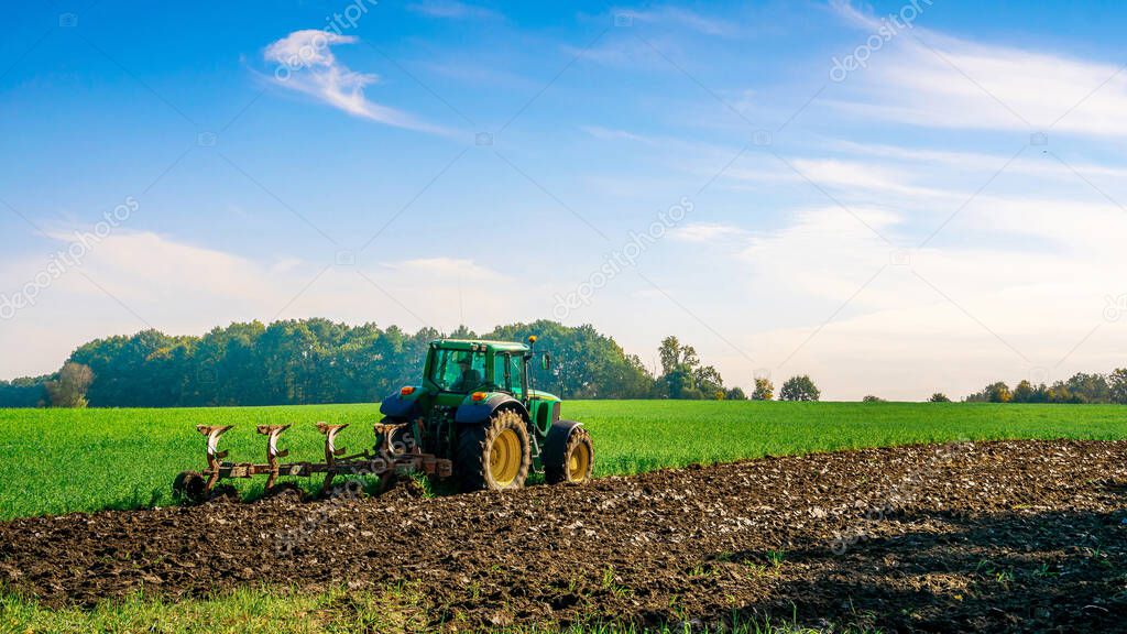 Tractor farm. Agriculture farm machinery on landscape land field. Farmer machine equipment for crop. Tractor farm fields concept.