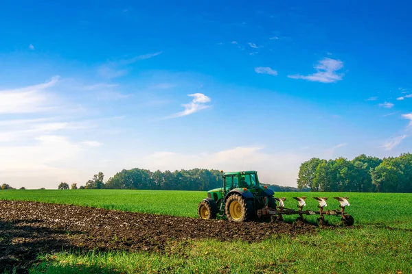 Tractor farm. Agriculture farm machinery on landscape land field. Farmer machine equipment for crop. Tractor farm fields concept