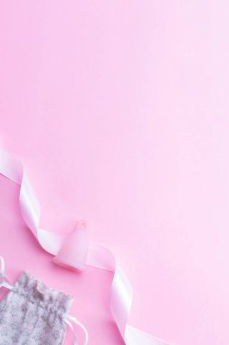 Menstrual cycle sanitary cup. Pink ribbon with menstrual cup. Menstruation feminine period. Sanitary hygiene banner. Use menstrual cup inside vagina