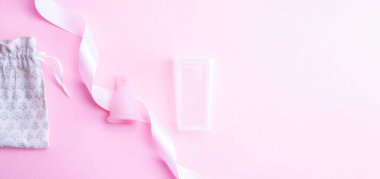 Menstrual cycle sanitary cup. Pink ribbon with menstrual cup. Menstruation feminine period. Sanitary hygiene banner. Use menstrual cup inside vagina