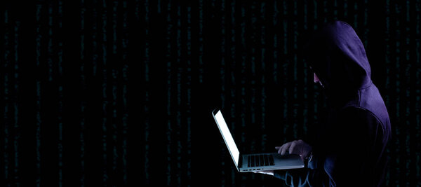 Cyber security hacker concept. Internet web hack technology. Digital laptop in hacker man hand isolated on black banner. Data protection, secured internet access, cybersecurity