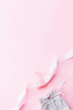 Menstrual cycle sanitary cup. Pink ribbon with menstrual cup. Menstruation feminine period. Sanitary hygiene banner. Use menstrual cup inside vagina