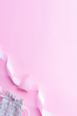 Menstrual cycle sanitary cup. Pink ribbon with menstrual cup. Menstruation feminine period. Sanitary hygiene banner. Use menstrual cup inside vagina