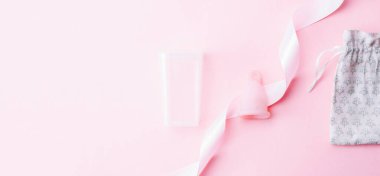 Menstrual cycle sanitary cup. Pink ribbon with menstrual cup. Menstruation feminine period. Sanitary hygiene banner. Use menstrual cup inside vagina