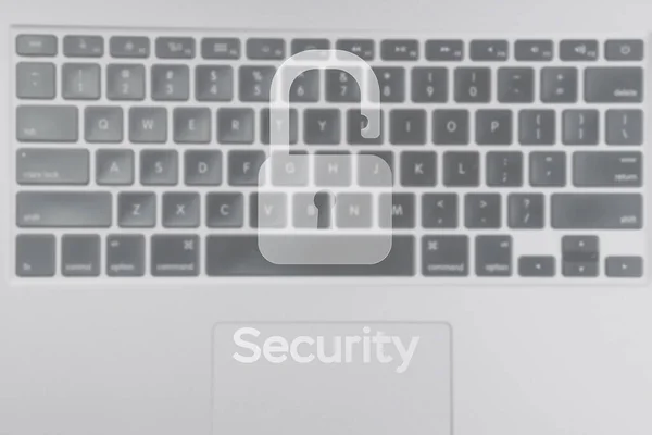 Safety computer security concept. Internet protection symbol on blured keyboard background. Concept image of security vulnerability and information leaks
