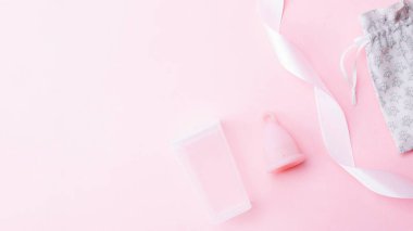 Menstrual cycle sanitary cup. Pink ribbon with menstrual cup. Menstruation feminine period. Sanitary hygiene banner. Use menstrual cup inside vagina